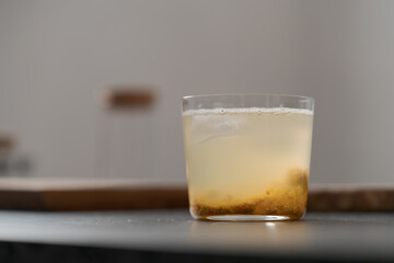 organic drink with lulo fruit in tumbler glass on concrete background with copy space