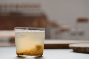 organic drink with lulo fruit in tumbler glass on concrete background with copy space