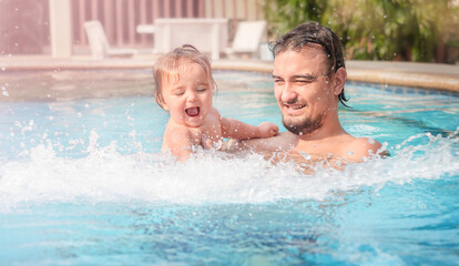Obraz na płótnie Canvas Father with a child in the pool.