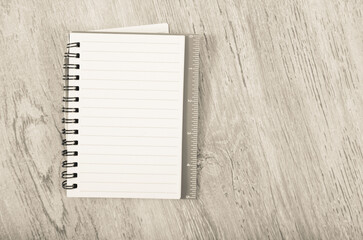 Spiral notebook with empty pages lying on wooden surface