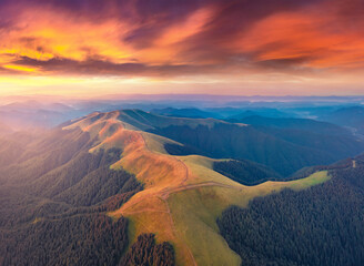 Fototapety  Aerial landscape photography. Breathtaking summer sunrise on Menchul ridge. Incredible morning view from flying drone of Carpathian mountains. Beauty of nature concept background.