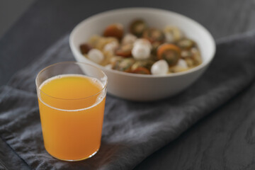 orange lemonade in glass tumbler glass on black wood table