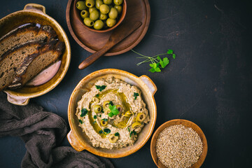 Arabic Aubergine paste or dip Baba Ghanoush with olives and sesame seeds