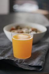 orange lemonade in glass tumbler glass on black wood table