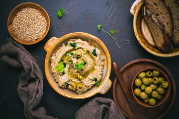 Arabic Aubergine paste or dip Baba Ghanoush with olives and sesame seeds