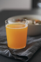 orange lemonade in glass tumbler glass on black wood table