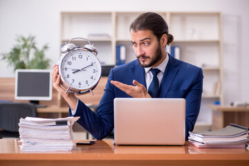 Young businessman employee in time management concept