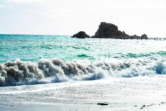 Coral reef in the black sea. Waves white sunny autumn day.