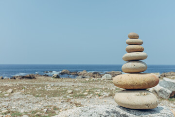 stones pyramid of pebbles on beach in portugal