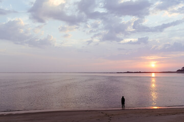 silhouette of person in sunset on beach