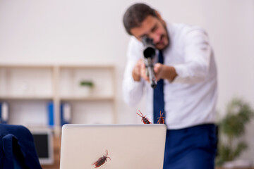 Young male employee and too many cockroaches in the office