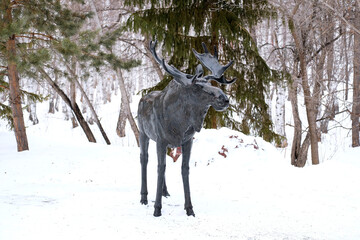Wrought iron moose in the park. Big black sculpture on the street. Bashkiria in the winter