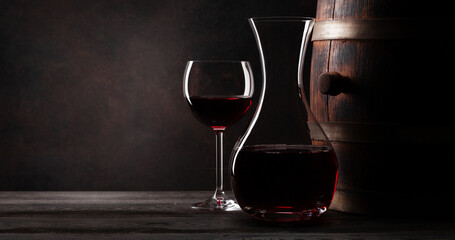 Fototapeta na wymiar Wine decanter, glavss and old wooden barrel