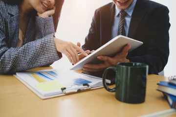 Cropped shot of two business people using digital tablet planning profitability and analyzing data and statistic in office.
