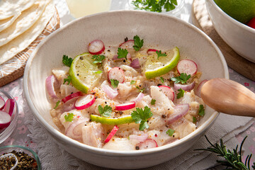 Close-up of a Peruvian ceviche with pieces of fish and lemons