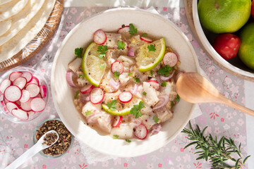 Close-up of a Peruvian ceviche with pieces of fish and lemons