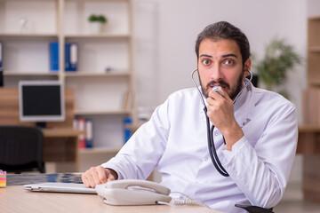 Young male doctor holding stethoscope at lab