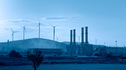 Industrial concept - Silhouette of Natural gas processing plant with Renewable energy wind turbines...