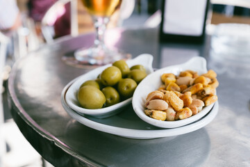 nuts and olives on plate on table