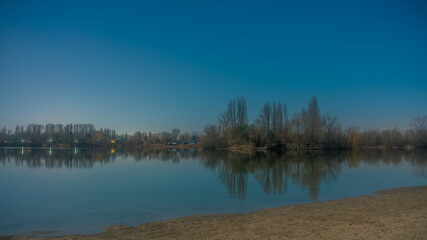 Obraz premium Panoramic landscape with the quarry lake Binsfeldsee near Speyer in Germany.
