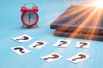 a question mark on a white sheet and a red alarm clock . FAQ frequency asked questions, Answer,...