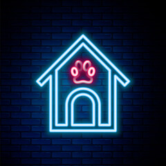 Glowing neon line Dog house and paw print pet icon isolated on brick wall background. Dog kennel. Colorful outline concept. Vector.