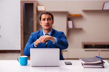 Young male employee working from home during pandemic
