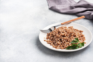 Boiled buckwheat on a plate. Healthy porridge enriched with vitamins. copy space, top view.