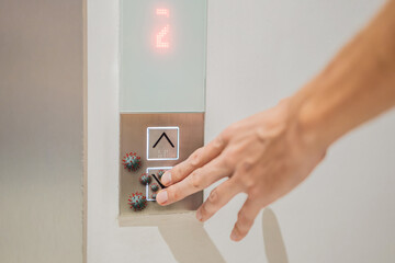 Hand finger press button in elevator with virus. Covid-19 or Coronavirus in the elevator button. Button with virus around the elevator or lift. Infection Control and Social distance concept