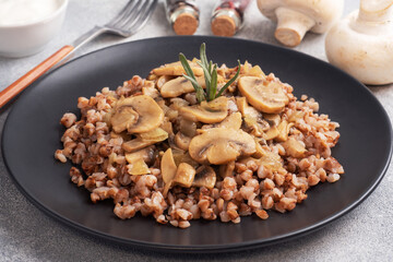 Boiled buckwheat with stewed mushrooms. Russian traditional food. Healthy diet food.