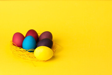 painted chicken eggs on a yellow background. Easter eggs. copyspace