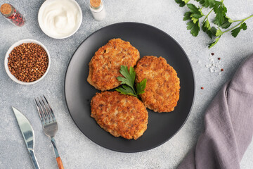 Buckwheat cutlets with cheese and parsley on a plate. Healthy diet food copy space, top view.
