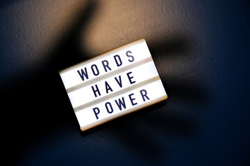 Lightbox with text WORDS HAVE POWER. Motivational Words Quotes Concept. Colorful background....