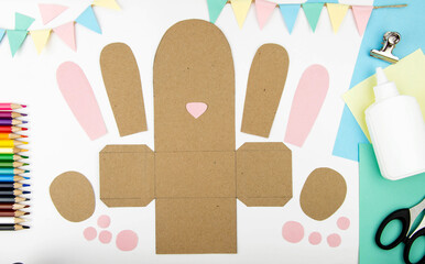 The concept of crafts with children for the Easter holiday. Step-by-step instructions for making craft paper bunny boxes. Step 2 - cut.