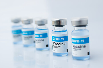 Group of Covid-19 Vaccine bottles with soft blurred effect focus only one bottle  