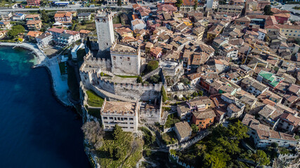 Fototapeta premium Incredible aerial view of the Medieval Castle of Malcesine on the shores of Lake Garda.