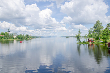 Obraz premium Scenic view of a still lake in summer
