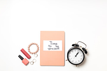 Time to be yourself lettering on a pink diary on a white background