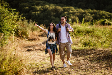 Happy couple is hiking in mountain.