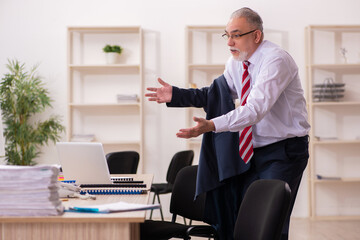 Old businessman employee sitting in the office