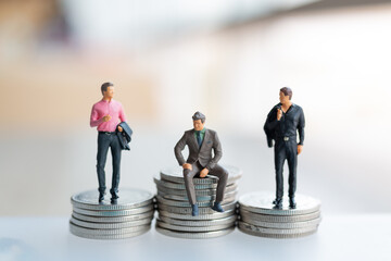 Miniature people businessman with coins. Business Growth concept