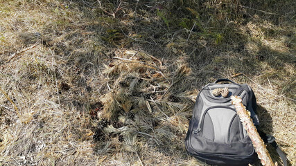 Tourist backpack on the background of the grass nature in mountain, traveler relax holiday concept, view planning trip vacation. Tourist destination. Anti-stress background. A soothing scene.