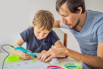 Fototapeta premium Boy and his father using 3d printing drawing pen. Creative, leisure, technology education concept