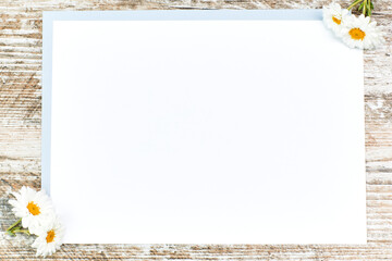 White daisies on a white sheet with copy space for text