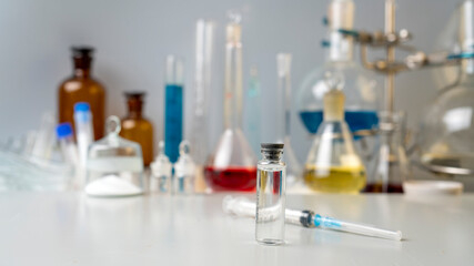 Photo Flasks with chemical powder, laboratory glassware with solutions on the table in the...