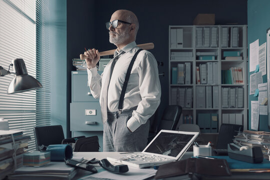 Angry stressed businessman with baseball bat