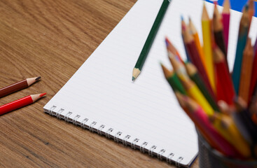 notebook and pencils on the table
