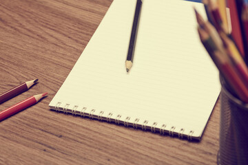 notebook and pencils on the table