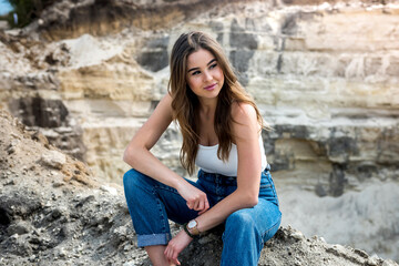 portrait of a girl enjoying summer vacation and sand quarry or canyon
