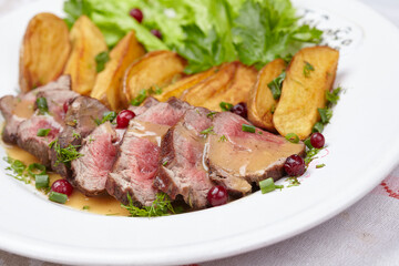Tasty roasted pork meat with potatoes